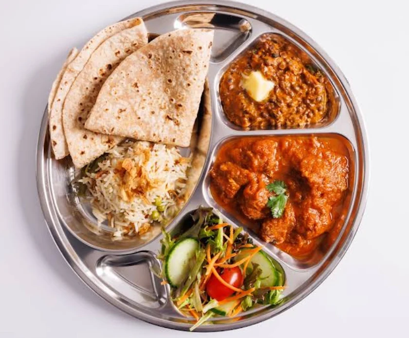 Thali with curries, rice, chapatis and salad